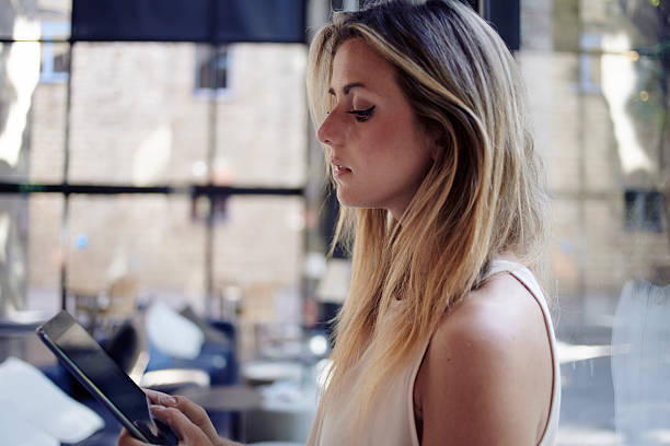 istock Female student reading electronic book on digital tablet 494850650