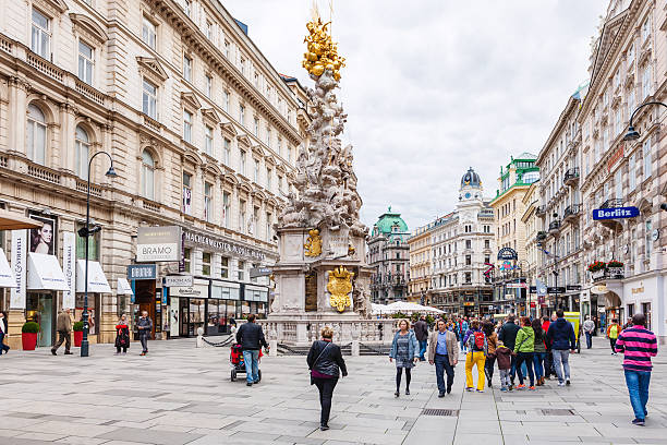 tourists on Graben street near Plague column Vienna, Austria - September 27, 2015: tourists on Graben street near Plague column (Pestsaule) in Vienna. The Graben is one of the most famous streets in Vienna first district, the city centre. people shopping in graben street vienna austria stock pictures, royalty-free photos & images