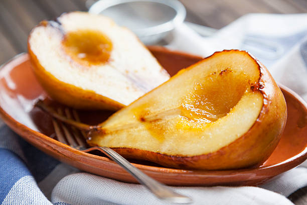 caramelized pear caramelized pear in the plate on the table view of the top pear dessert stock pictures, royalty-free photos & images