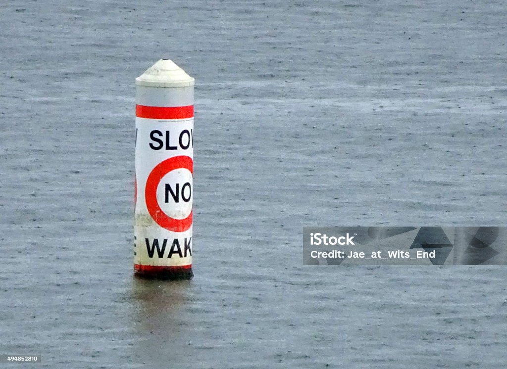 Buoy No Wake No wake warning buoy on a lake in the rain. 2015 Stock Photo