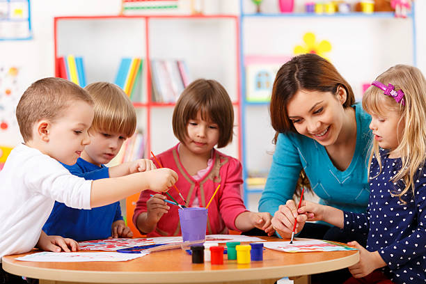 istock Group Of Elementary Age Children In Art Class With Teacher 494853971