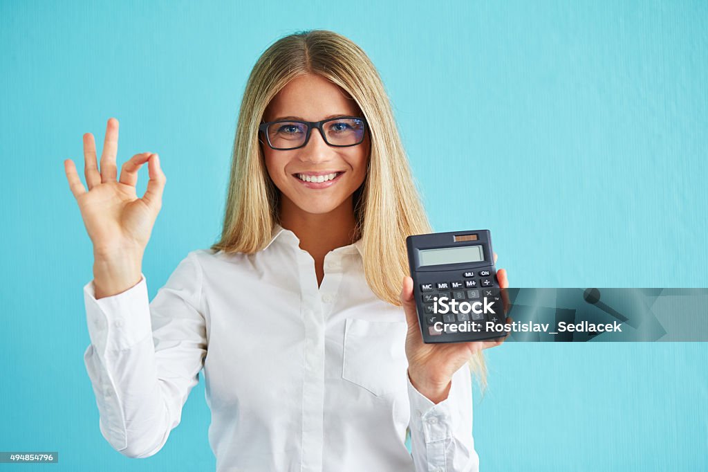 Business woman with calculator Young business woman show calculator and gesture ok Calculator Stock Photo