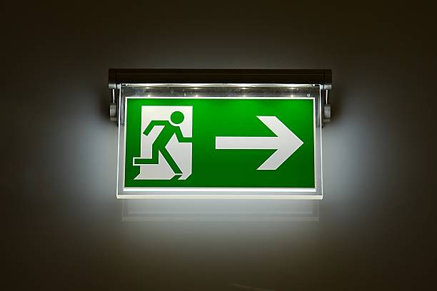 Exit Sign Emergency exit sign glowing in the dark exit sign photos stock pictures, royalty-free photos & images