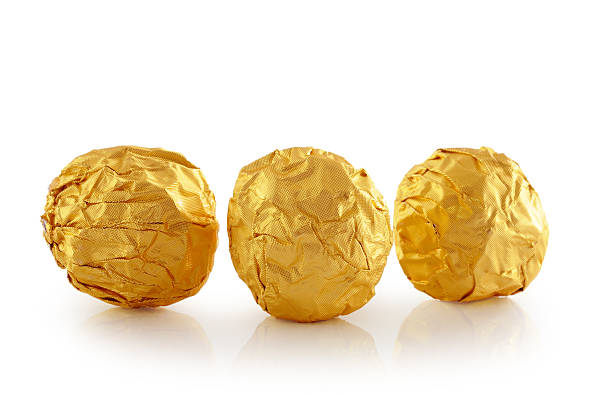 istock Sweet chocolate candy wrapped in golden foil 494855175