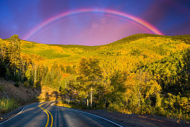 Rainbow Over an Aspen Forest Dramatic rainbow over the Santa Fe Ski Basin highlighting beautiful aspens and pine trees santa fe new mexico stock pictures, royalty-free photos & images