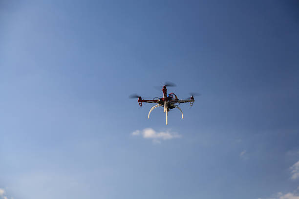 istock Drone flying in the air under a blue sky 494856661