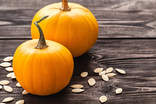 istock Pumpkin on wooden board black color. 494877920