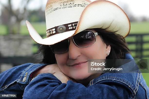Content Woman Wears Cowboy Hat And Sunglasses Stock Photo - Download Image Now - 2015, Adult, Adults Only