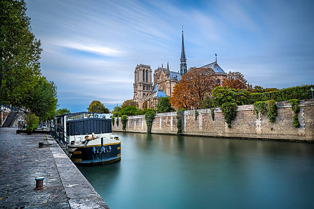 Notre Dame with boat on Seine in Paris, France stock photo