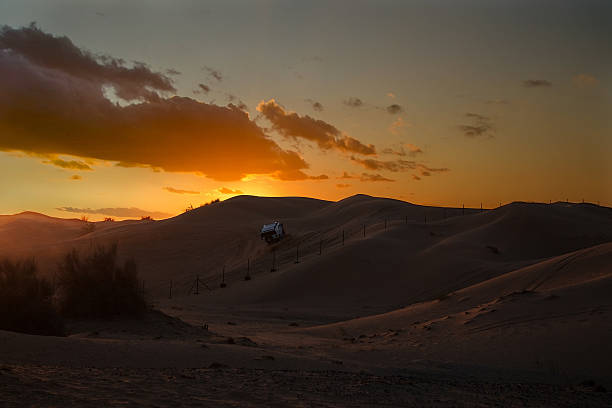 Safari sunset and suv in desert