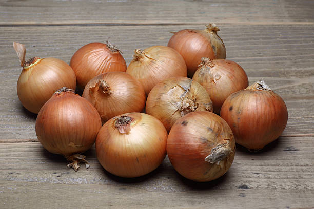 istock Onions on a wooden background 494881202