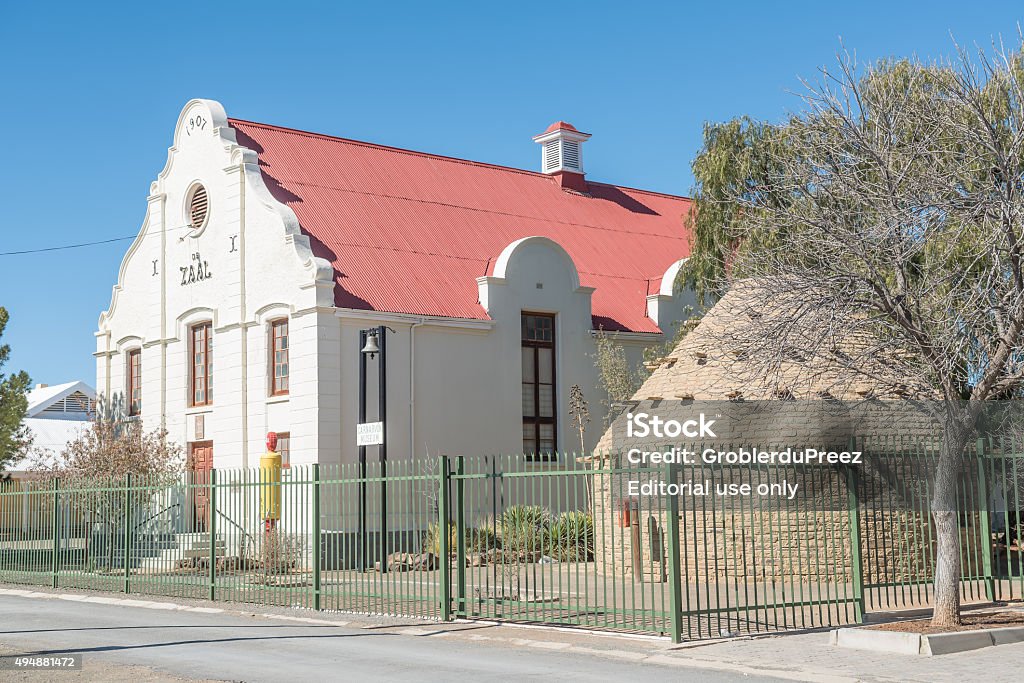 Museum in Carnavon Carnavon, South Africa - August 10, 2015: The museum was built in 1907 as a community hall for the Dutch Reformed Church. A corbelled house and old fuel pump is visible 2015 Stock Photo