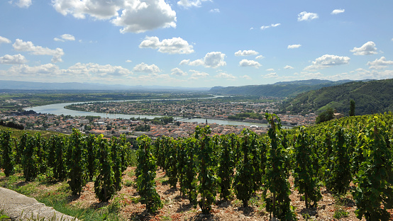 The towns of Tournon-sur-Rhône and Tain l'Hermitage crossed by the rhône river. In the background the famous vineyard of Croze-Hermitage