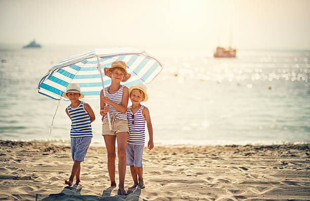 istock Kids enjoying summer vacation on the beach 494882710