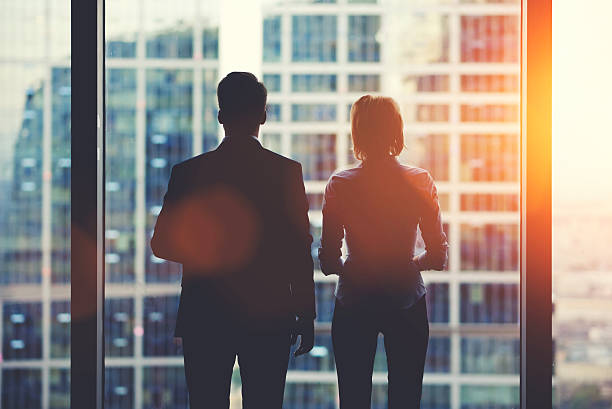 istock Businesspeople in fear or risk watching cityscape from skyscraper interior 494888972