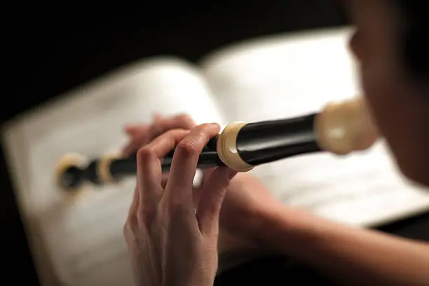 detail photograph of a woman who plays the flute focus on fingers