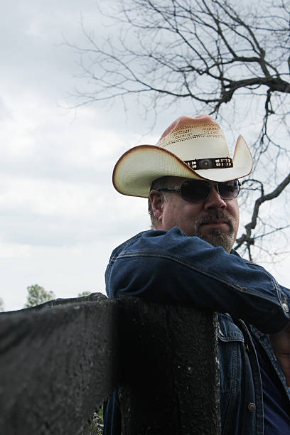 istock Man Wearing Cowboy Hat Looks to the Right While Posing 494891816