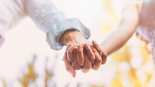 istock Close up on couple holding hands 494892262