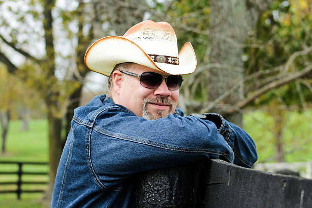 istock Grinning Man Wearing Cowboy Hat Poses For Camera 494892568