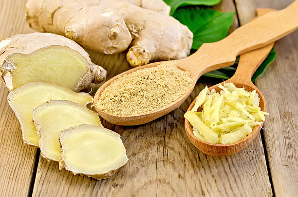 istock Ginger powder and grated in spoon with root and leaves 494892581