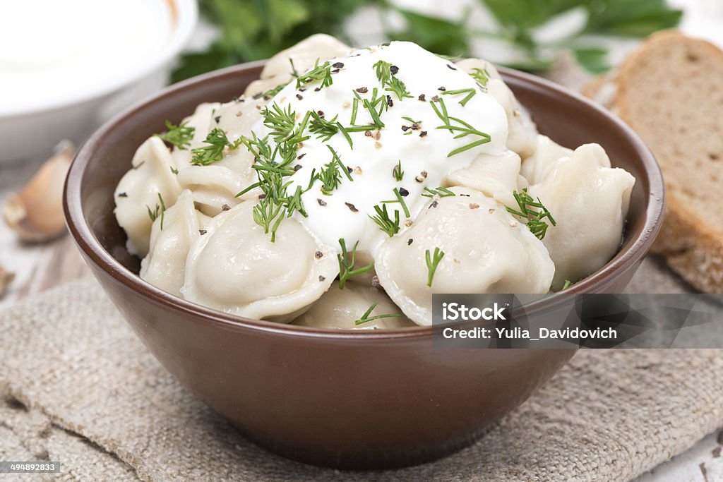 traditional Russian dumplings with sour cream, close-up traditional Russian dumplings with sour cream, close-up, horizontal Appetizer Stock Photo