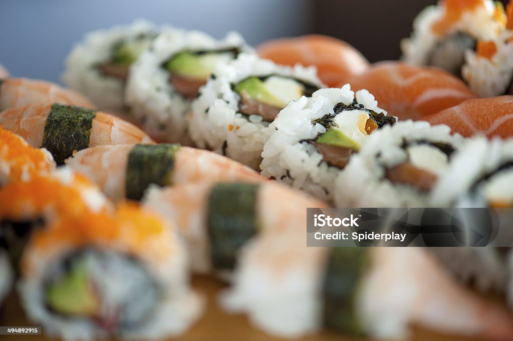 Sushi Assortment A variety of sushi and maki rolls sitting on a restaurant counter. Appetizer Stock Photo