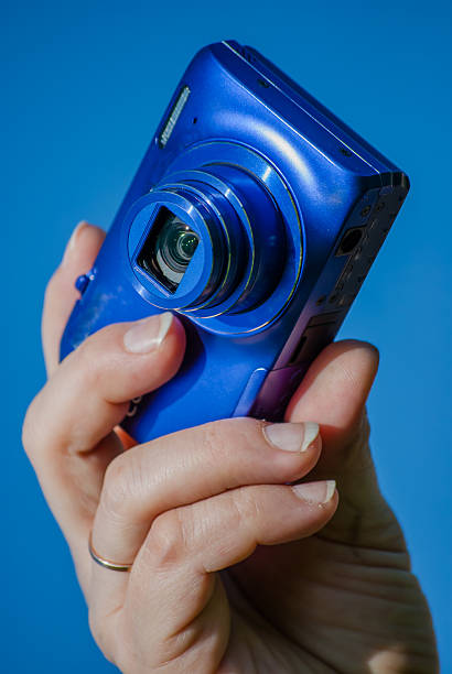istock woman's hand with photocamera 494894689