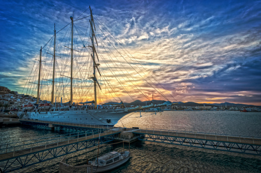 A HDR picture taken in Ibiza Town, Ibiza.  The sunsets behind the large sailing vessel in the marina.