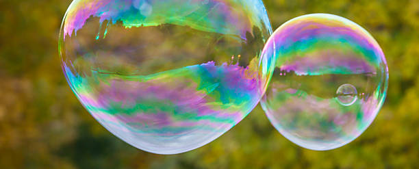 istock soap bubbles flying in the air with trees background 494895896