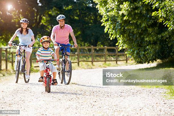 Asian Family On Cycle Ride In Countryside Stock Photo - Download Image Now - Family, Cycling, Bicycle