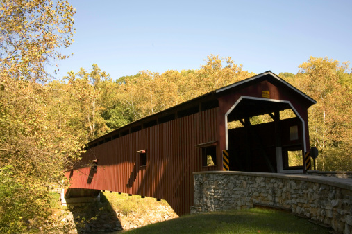 Colemanville Covered Bridge in the Pennsylvania Dutch Countryside of Lancaster County surrounded by fall folliage.
