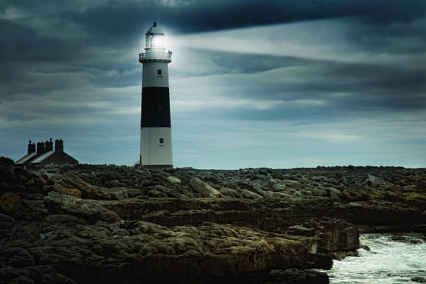 istock lighthouse at stormy irish coast 494897515