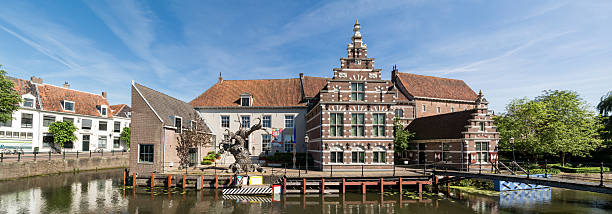 A canal and the tower of the Waag in the city of Alkmaar, The Netherlands.