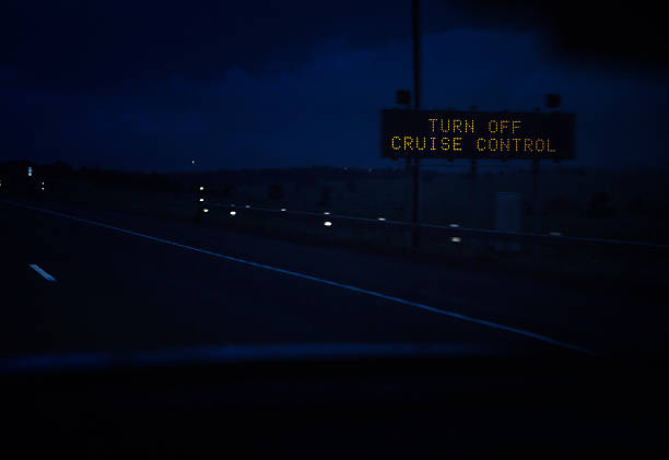 istock TURN OFF CRUISE CONTROL Road Sign On Night Expressway 494900108