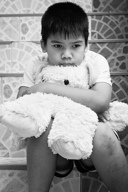 istock little boy sitting alone at staircase in the park 494900264
