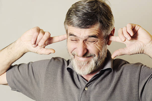 I can not hear you!
Close up portrait of a senior man with his fingers in ears man closing ears photos stock pictures, royalty-free photos & images