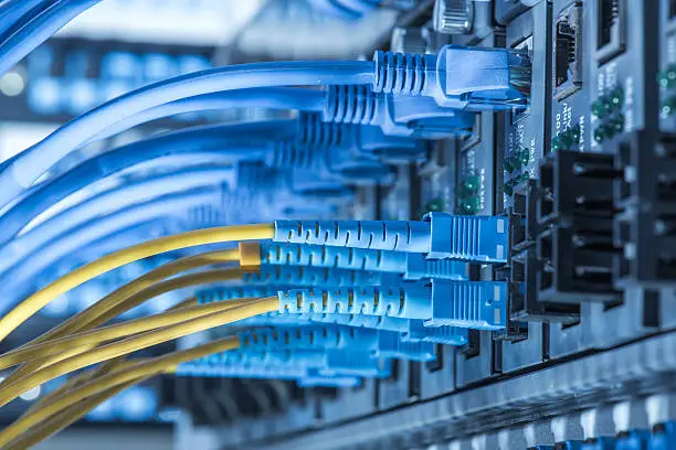 Fiber Optic cables and UTP Network cables connected hub ports.