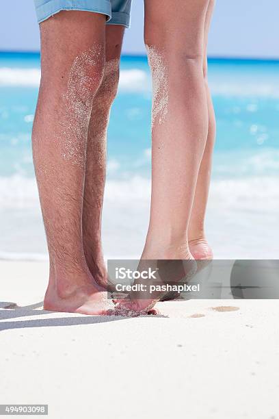 Couple Of Male And Female Legs On Beach Stock Photo - Download Image Now - 2015, Adult, Backgrounds