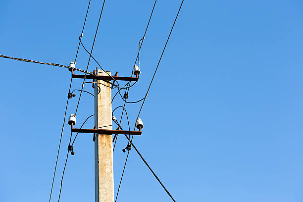 istock Electricity pylons against blue sky 494905714