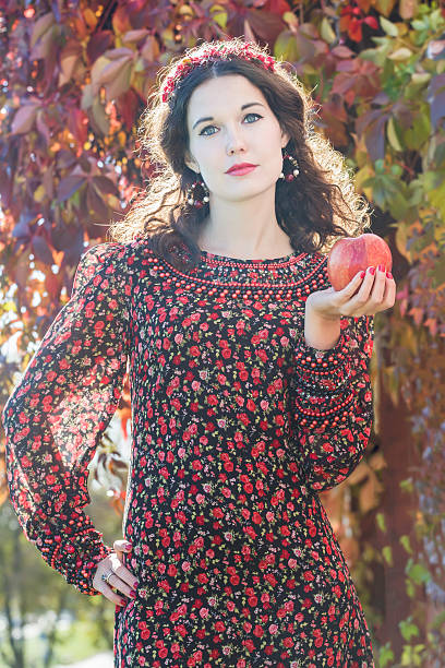istock Autumn girl in fall head wreath with ripe apple 494914076