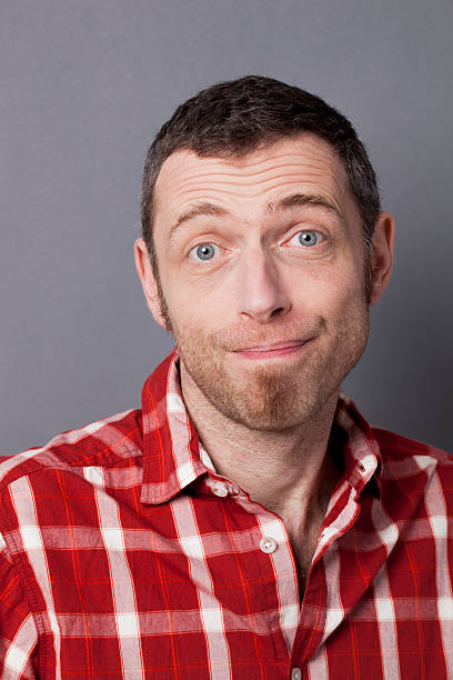 istock dumbstruck 40s man smiling surprised by himself 494914348