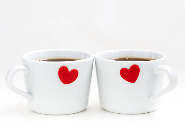 istock White coffee cups with red hearts, closeup 494914486