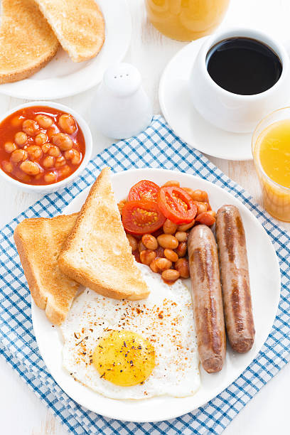 istock traditional English breakfast with sausages, top view 494914870