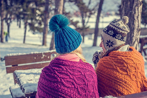 Back of young person in hat with backpack