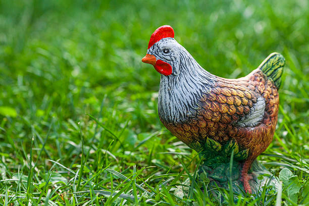 Decorative ceramic hen on a green grass