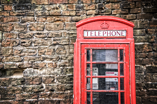 Old classic red telephone booth with copy space