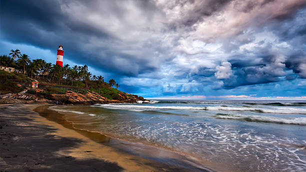 мероприятия storm, пляж, маяк. керала, индия - lighthouse storm sea panoramic стоковые фото и изображения
