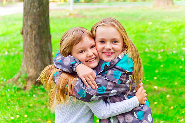 istock Cute two embracing girls 494928400