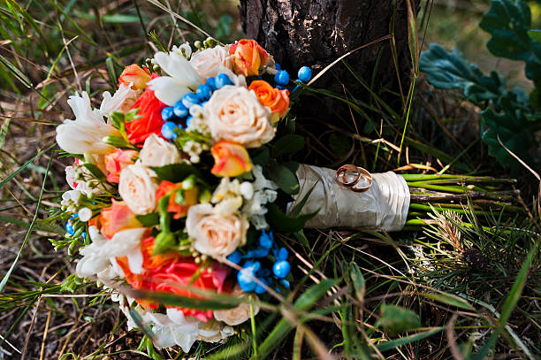 istock wedding bouquet with rings at pine forest 494928942