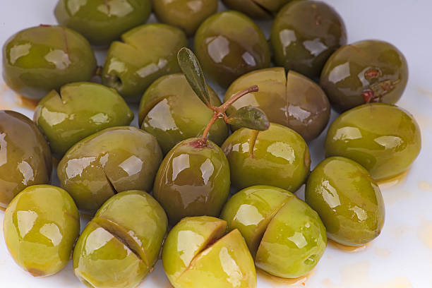 Green olives, broken style stock photo
